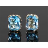 9 carat gold blue topaz set earrings, with an emerald cut blue topaz to each stud, 10mm high, (2)