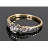 18 carat gold diamond set ring, the central diamond at approximately 0.45 carat in size flanked by a