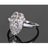 Diamond set ring, the head in the form of a pear shape and bow top all set with diamonds, ring