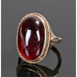 9 carat gold cherry amber ring, the cabochon cut cherry amber head with a rope twist edge, ring size