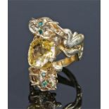 Impressive Ceylon yellow sapphire and emerald ring, in the Oriental taste, with a pair of coiled