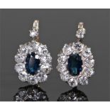 Pair of sapphire and diamond set earrings, the central sapphire with diamond surround, 17mm high