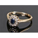 18 carat gold sapphire and diamond ring, the central oval sapphire with diamond surround, ring