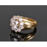 Cartier, a diamond set flower head ring, the central diamond at approximately 1.2 carat with a round