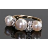 18 carat gold pearl and diamond set ring, with three pearls separated by four diamonds, ring size