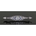 Diamond and sapphire brooch, the central round cut diamond at 0.87 carat with a diamond and cross