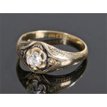 18 carat gold diamond set mourning ring, the central round cut diamond at approximately 0.34 carat