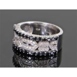 18 carat white gold diamond and black diamond ring, half the ring set with a central diamond swirl