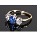 Sapphire and diamond set ring, the central sapphire at approximately 1.2 carats flanked by a diamond