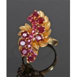 18 carat gold ruby set ring, the round and oval rubies set to leaf design, ring size M