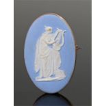 Wedgwood brooch, the jasper panel with a maiden in white on a pale blue ground, set within a 9 carat