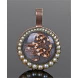 19th Century gold and pearl pendant, with a row of graduating pearls around the monogramed interior,