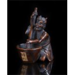 Edo period Okimono Oni shoko carved as a kneeling Oni stirring a cauldron signed to the base 55mm