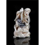 19th Century Japanese ivory Okimono, carved as a figure holding a knife above the head of a female