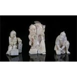 Three early 20th Century Japanese ivory okimono's, the first a man with a fox in a bag, 7cm high,