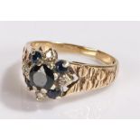 9 carat gold sapphire set ring, in the form of a flower head, ring size M