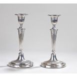 Pair of silver candlesticks, Sheffield date letter rubbed, with tapering stems and oval bases,