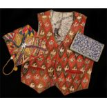 Waistcoat with embroidered floral decoration, cowrie shell decorated bag, floral fabric covered