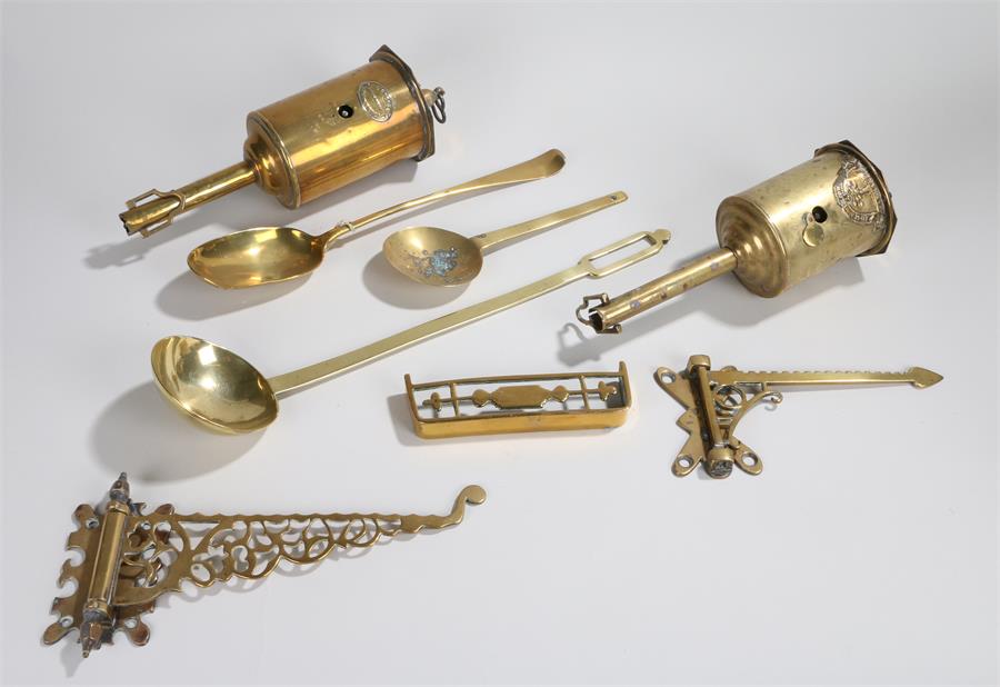 Two brass roasting jacks, two brass swing brackets, two brass spoons, a ladle, a small brass footman
