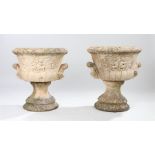 Pair of composite garden urns, with classical figures to the bodies and shell capped handles, 60cm