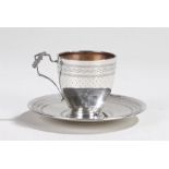 French silver cup and saucer, the cup with wreath decorated handle, the cup and saucer with blank