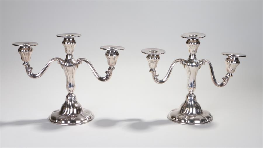 Pair of silver plated two branch candelabra, circa 1940's, with a central beam flanked by the lappet