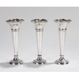Three George V silver tulip vases, Sheffield 1918, makers Walker and Hall, with flared rims,