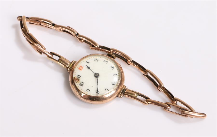 9 carat gold ladies wristwatch, with a white enamel dial and gold elasticated strap