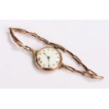 9 carat gold ladies wristwatch, with a white enamel dial and gold elasticated strap