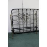 Steel and brass double bed, with flower head and scroll decorated head and foot board, with irons