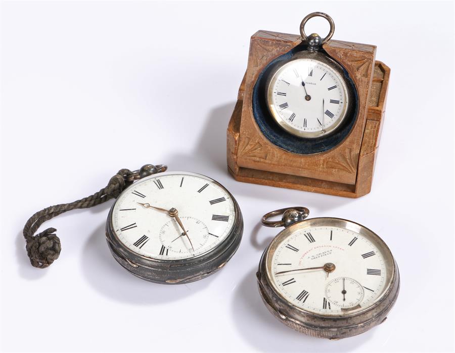 Three silver pocket watches, the first within a watch case, the second with a subsidiary dial and