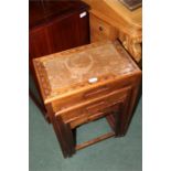 Nest of three hardwood occasional tables, the largest 44cm wide