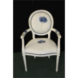 French style white painted armchair, floral upholstered back and seat, on reeded legs