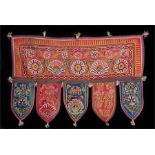 Indian textile hanger, decorated with flowers and elephants on a red and blue ground, 65cm long