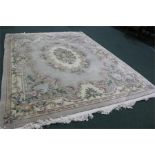 Chinese embossed carpet, the central field with floral decoration and taselled ends