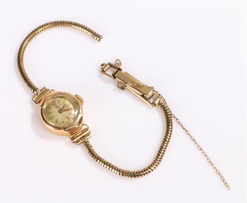 9 carat gold ladies wristwatch, with a silvered dial, manual wound