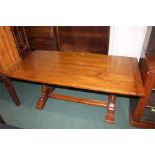 Reproduction oak refectory dining table, on turned supports, flattened stretcher and sledge feet,