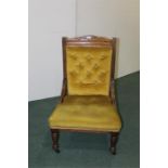 Edwardian upholstered nursing chair, on turned legs and castors