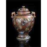 Japanese satsuma pottery lidded vase,decorated with a collection of figures with a rocky background,