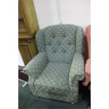 Armchair upholstered in a green patterned material