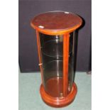 Reproduction mahogany veneered display cabinet, of cylindrical form with single door opening to