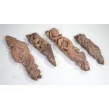 Four 18th Century Indian carved corbel brackets, the four pieces carved with scrolls and fish,