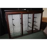 Mahogany display cabinet with central glazed panel flanked by two glazed doors, adjustable glass