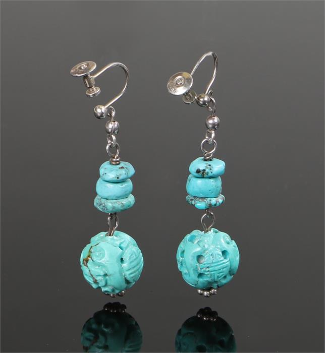 Pair of carved turquoise earrings, with three pebbles above a carved drop, 35mm long