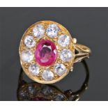 Ruby and white sapphire set ring, the yellow metal ring with a central ruby and white sapphire