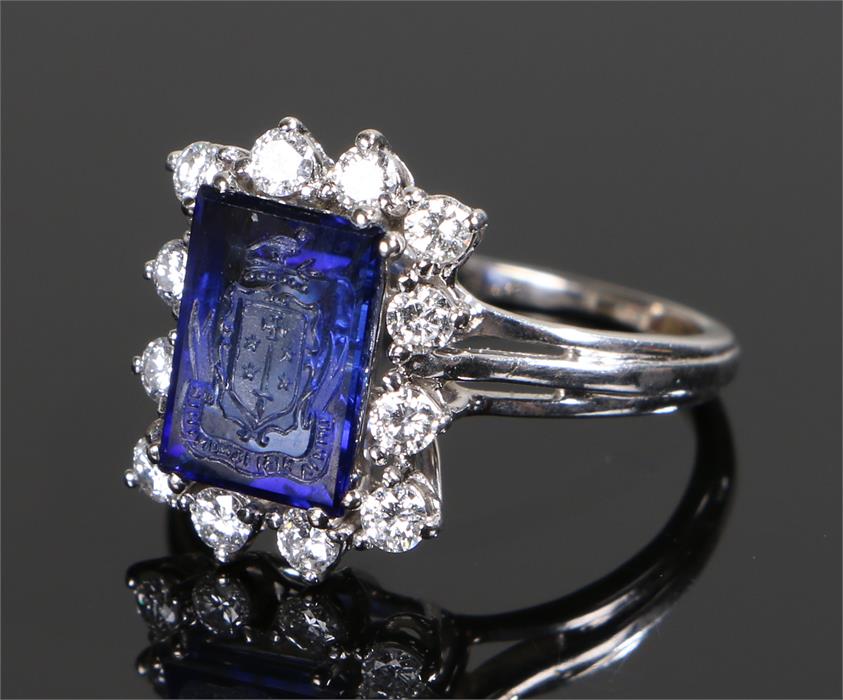 Unusual diamond and intaglio ring, the blue intaglio carved with a crest having twelve round cut