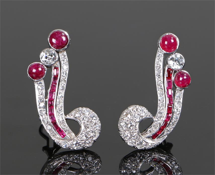 Fine pair of diamond and ruby earrings, set with an estimated 3.8 carat of cabochon and baguette cut