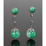 Pair of jade and diamond set earrings having a dome jade to the top and a diamond set bar and claw