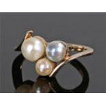 9 carat gold pearl set ring, the head with three pearls on a swirl mount, ring size P