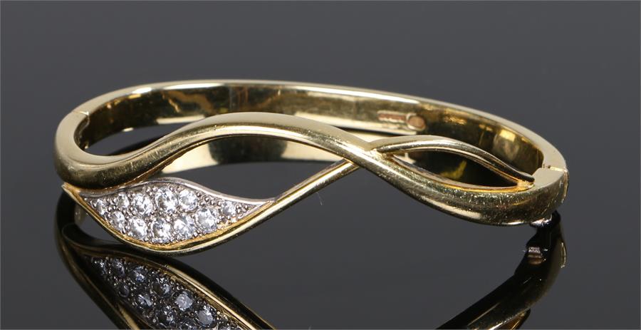 18 carat gold diamond set bracelet, the arching bracelet set with eleven round cut diamonds to a